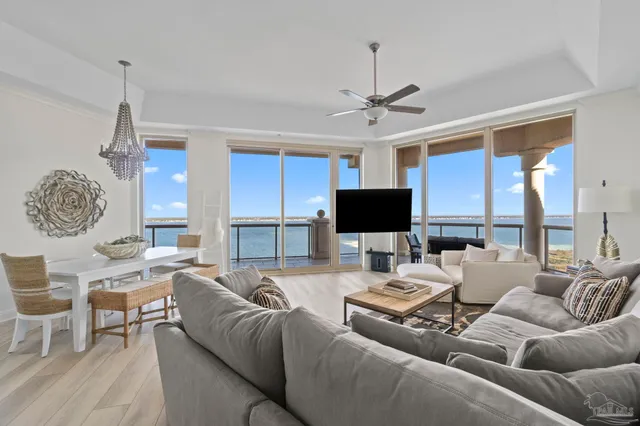a living room with furniture a ceiling fan and a flat screen tv