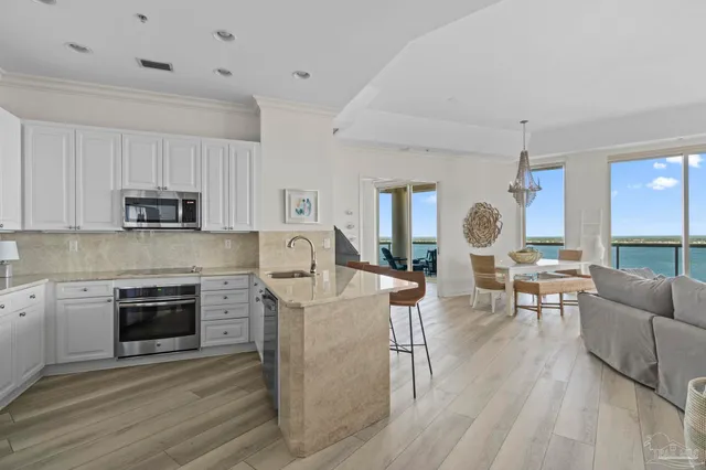a living room with furniture a fireplace and a dining table with wooden floor
