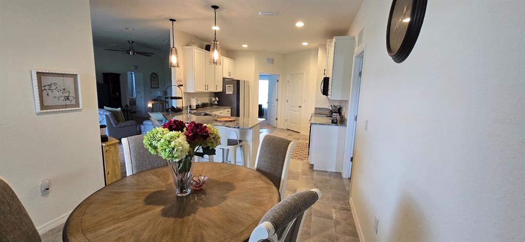 1108 Caloosa Ridge Way Babson Park, FL 33827 - Photo 12 of 29 a dining room with furniture cabinetry a chandelier and wooden floor