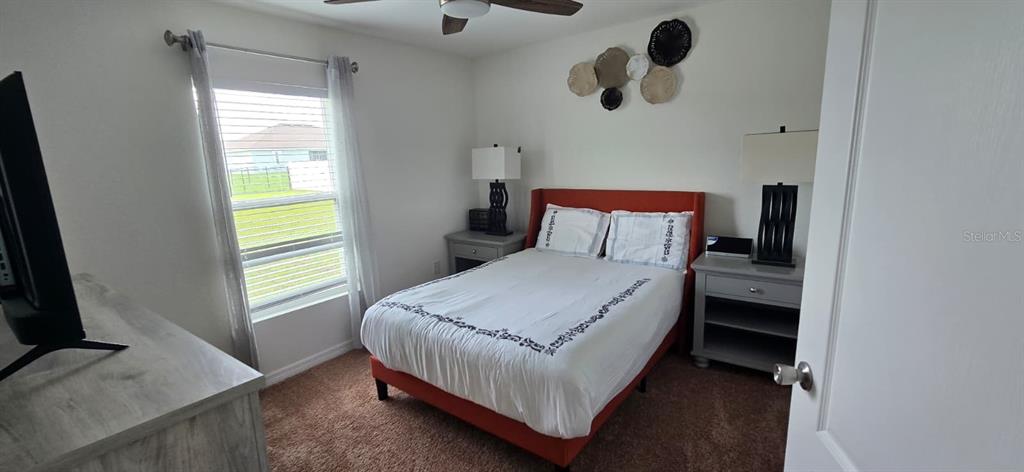 1108 Caloosa Ridge Way Babson Park, FL 33827 - Photo 13 of 29 a bedroom with a bed and window