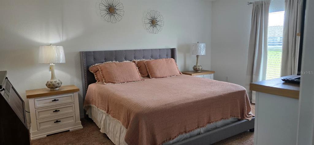 1108 Caloosa Ridge Way Babson Park, FL 33827 - Photo 17 of 29 a bedroom with a bed and a window