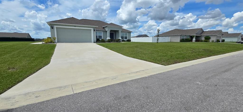 1108 Caloosa Ridge Way Babson Park, FL 33827 - Photo 2 of 29 a front view of house with yard and green space