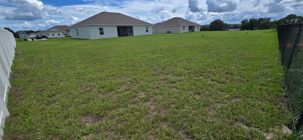 1108 Caloosa Ridge Way Babson Park, FL 33827 - Photo 27 of 29 a view of a yard in front of a house with a big yard