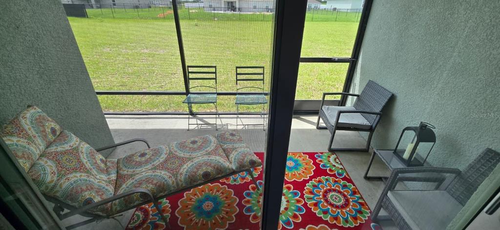 1108 Caloosa Ridge Way Babson Park, FL 33827 - Photo 28 of 29 a living room with furniture and a floor to ceiling window