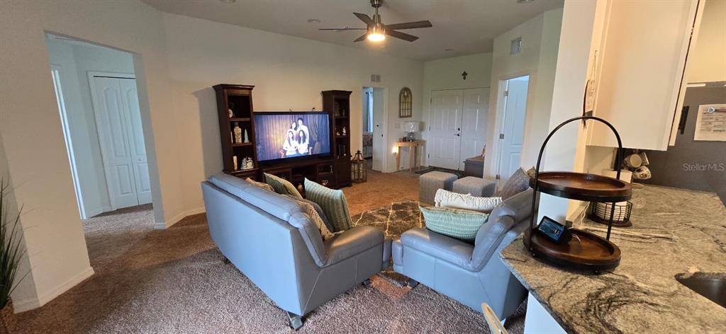 1108 Caloosa Ridge Way Babson Park, FL 33827 - Photo 8 of 29 a living room with furniture and a flat screen tv