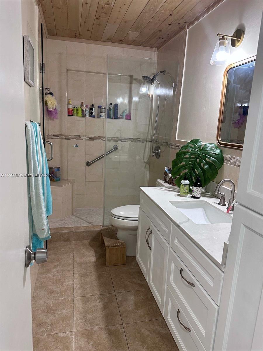 6174 West 14th Court, Unit 1 Hialeah, FL 33012 - Photo 13 of 24 a bathroom with a sink a toilet and mirror