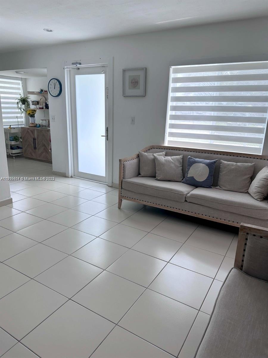 6174 West 14th Court, Unit 1 Hialeah, FL 33012 - Photo 18 of 24 a living room with furniture and a window