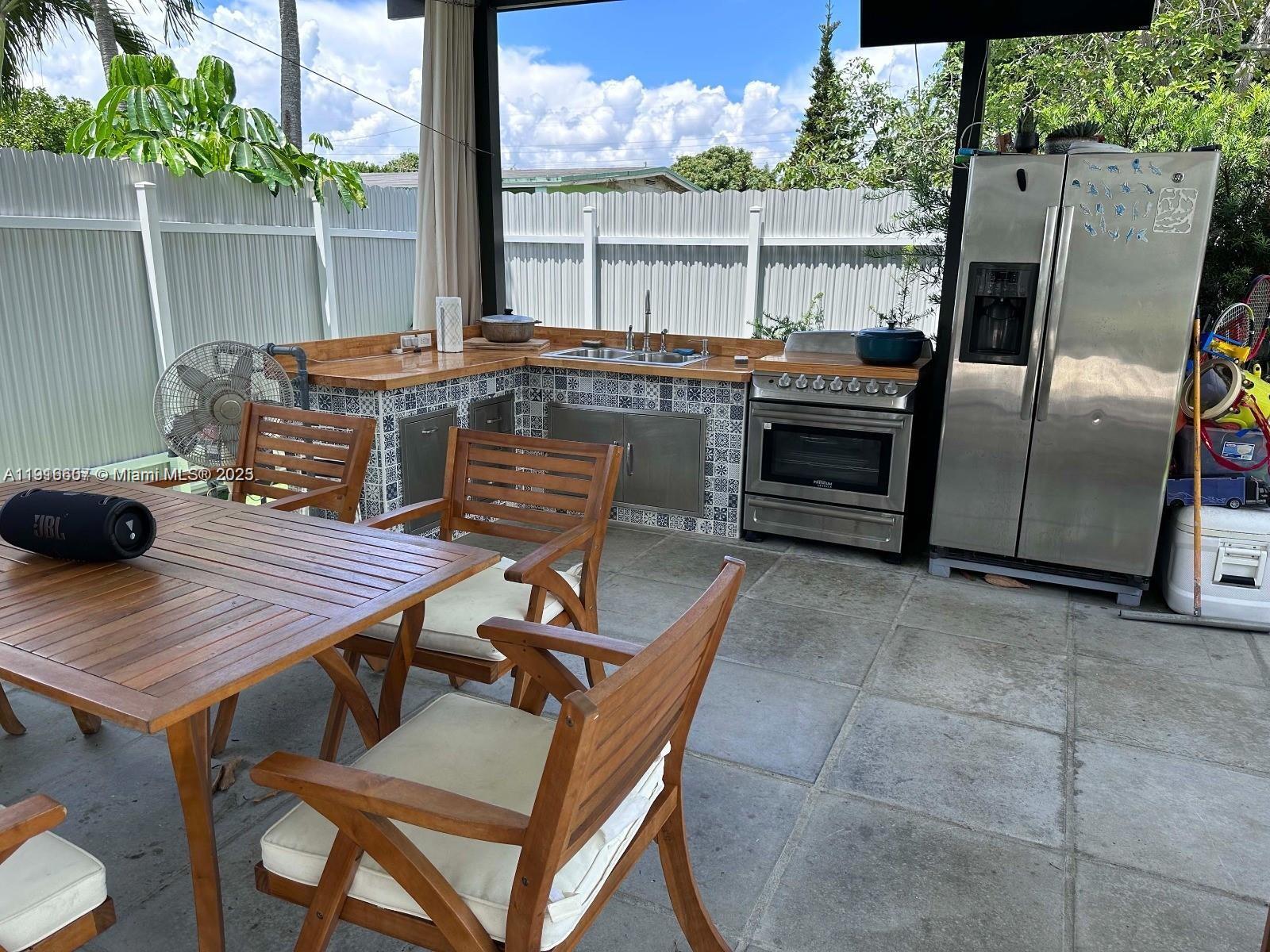 6174 West 14th Court, Unit 1 Hialeah, FL 33012 - Photo 24 of 24 a patio with table and chairs