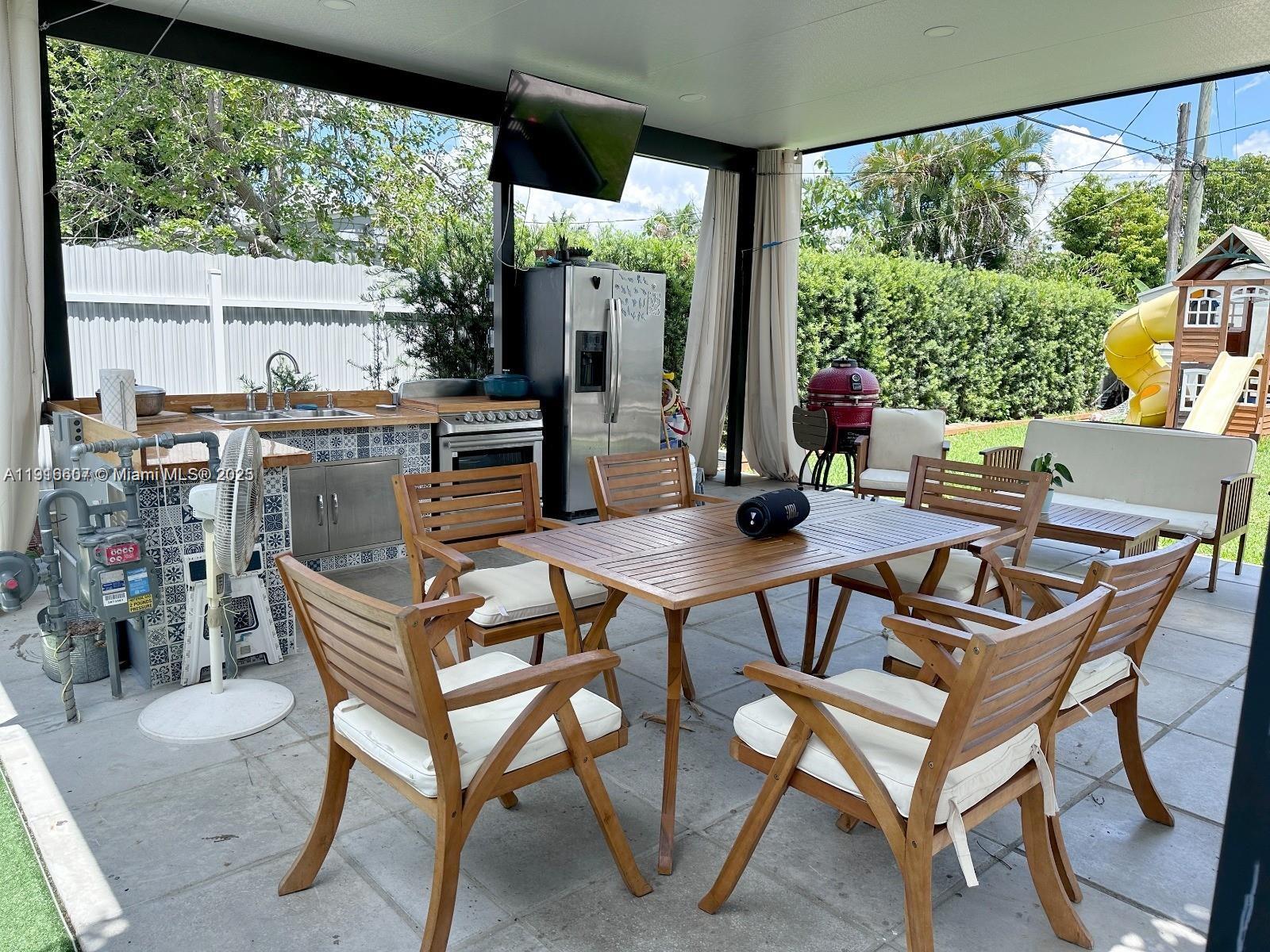 6174 West 14th Court, Unit 1 Hialeah, FL 33012 - Photo 6 of 24 a view of a dining room with furniture window and outside view