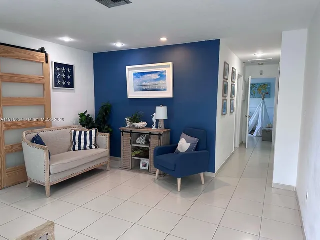 a living room with furniture and a black gate