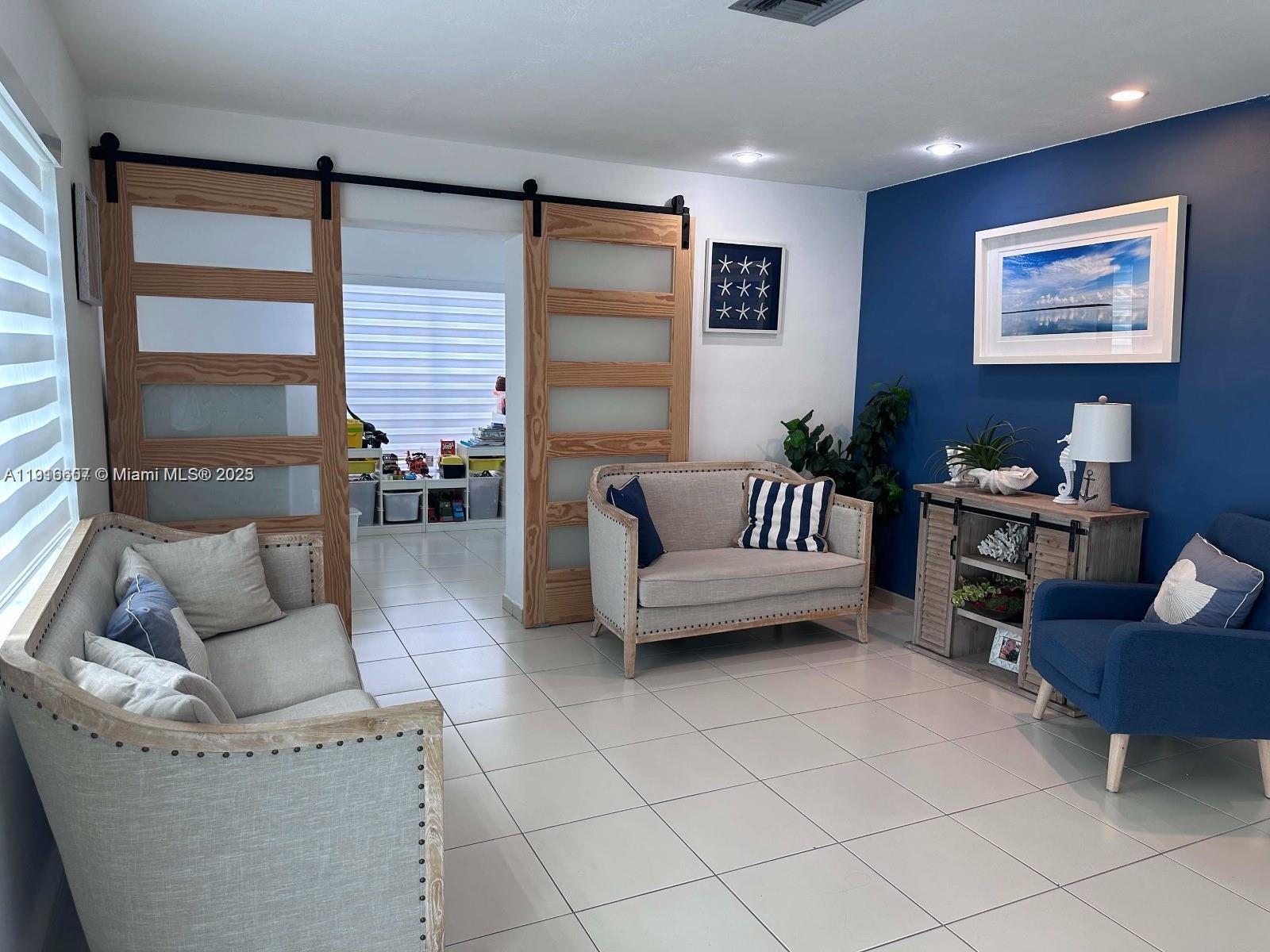 6174 West 14th Court, Unit 1 Hialeah, FL 33012 - Photo 8 of 24 a living room with furniture and a large window