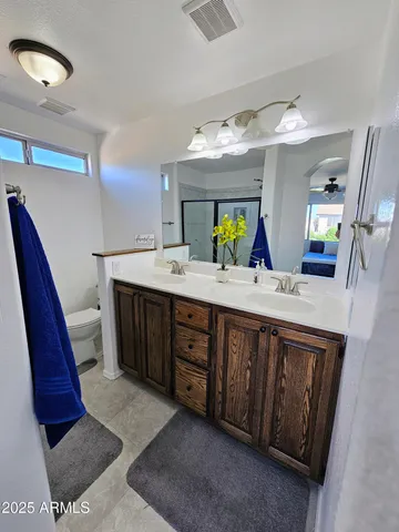a bathroom with a double vanity sink and a mirror