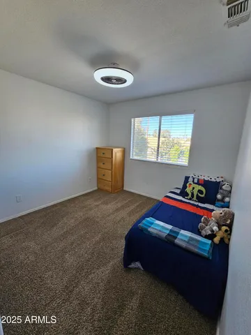 a living room with a bed and cabinets