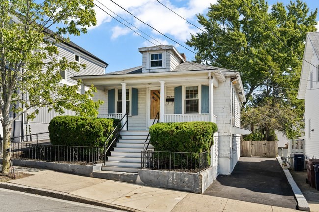 53 Windsor Street Everett, MA 02149 - Photo 16 of 20 a front view of a house with a garden