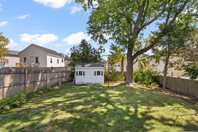 53 Windsor Street Everett, MA 02149 - Photo 18 of 20 a view of a house with a yard