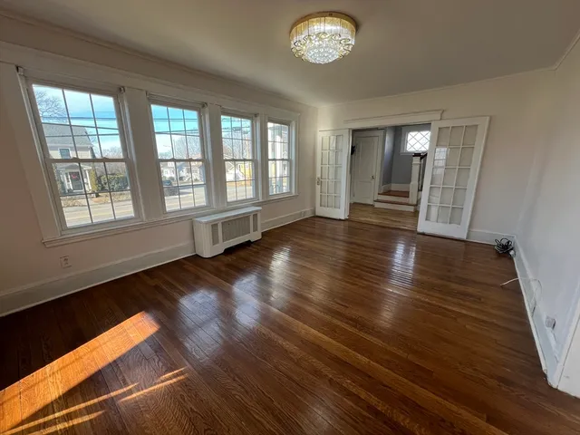 wooden floor in an empty room with a window