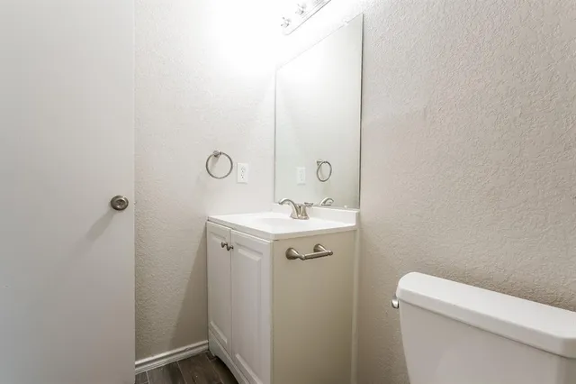 a bathroom with a sink a toilet and mirror