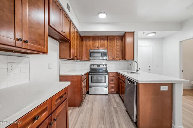 a kitchen with stainless steel appliances granite countertop a stove and a sink