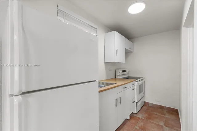 a utility room with cabinets washer and dryer