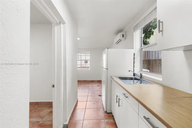 a spacious bathroom with a granite countertop sink and a mirror