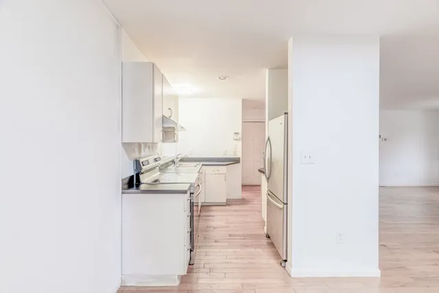 a view of a kitchen with an empty space and a window