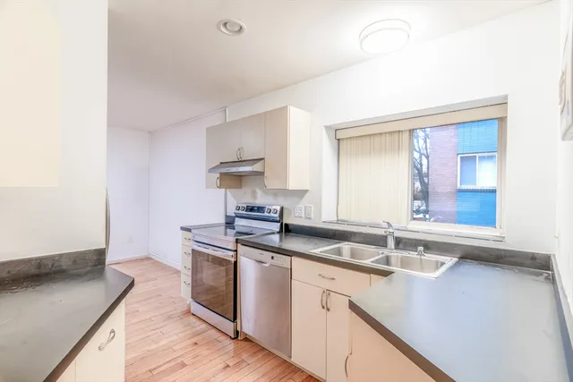 a kitchen with stainless steel appliances a refrigerator and a stove