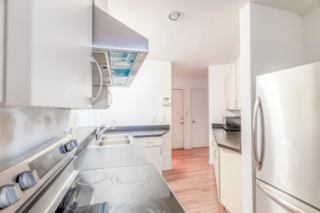 a bathroom with a sink mirror vanity and toilet