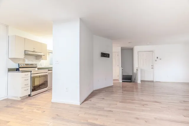 a view of a hallway with an entryway door