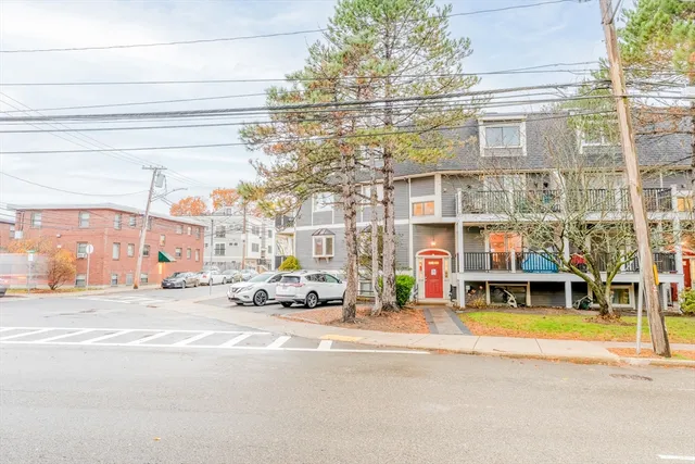 a view of a hallway with wooden floor and entryway