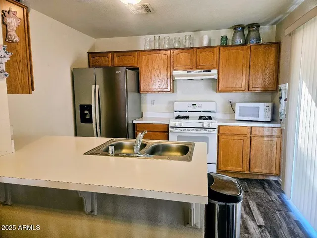 a kitchen with a sink stove and refrigerator