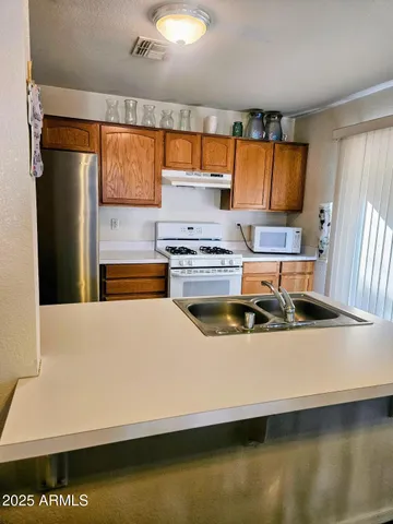a kitchen with a stove and a refrigerator