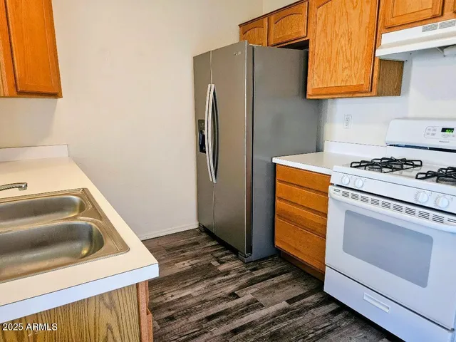 a kitchen with a stove and a refrigerator