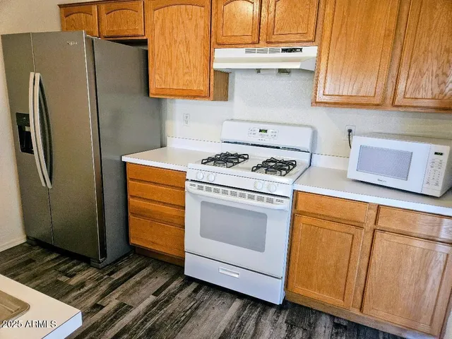 a kitchen with appliances and cabinets