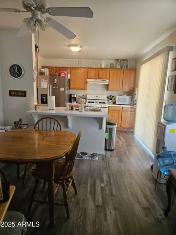 a dining room with a table chairs and a kitchen view