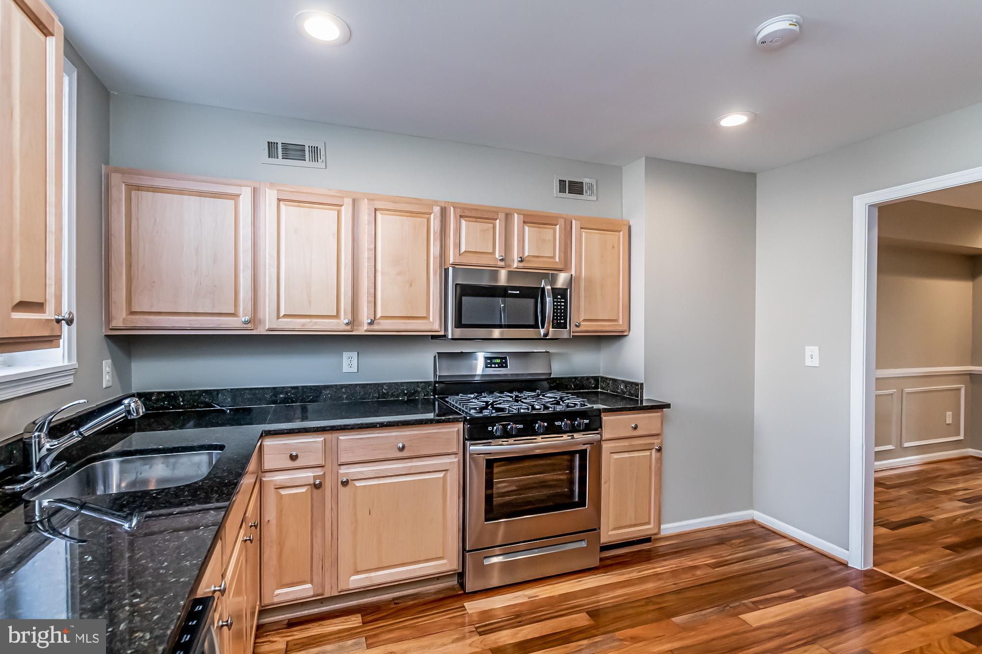 130 West Randall Street Baltimore, MD 21230 - Photo 11 of 30 a kitchen with granite countertop a stove and a sink