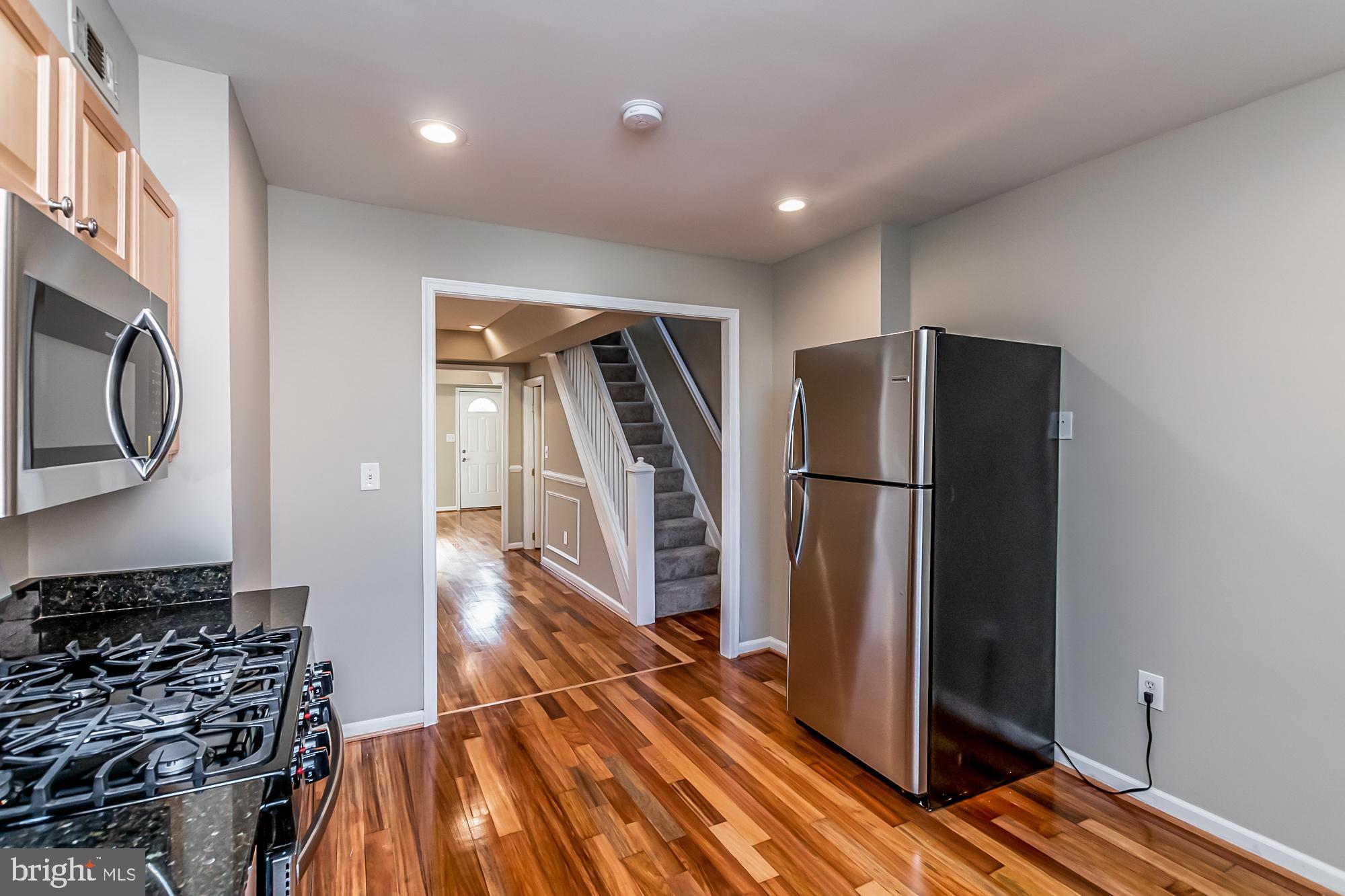 130 West Randall Street Baltimore, MD 21230 - Photo 13 of 30 a kitchen with stainless steel appliances granite countertop a refrigerator and a stove top oven