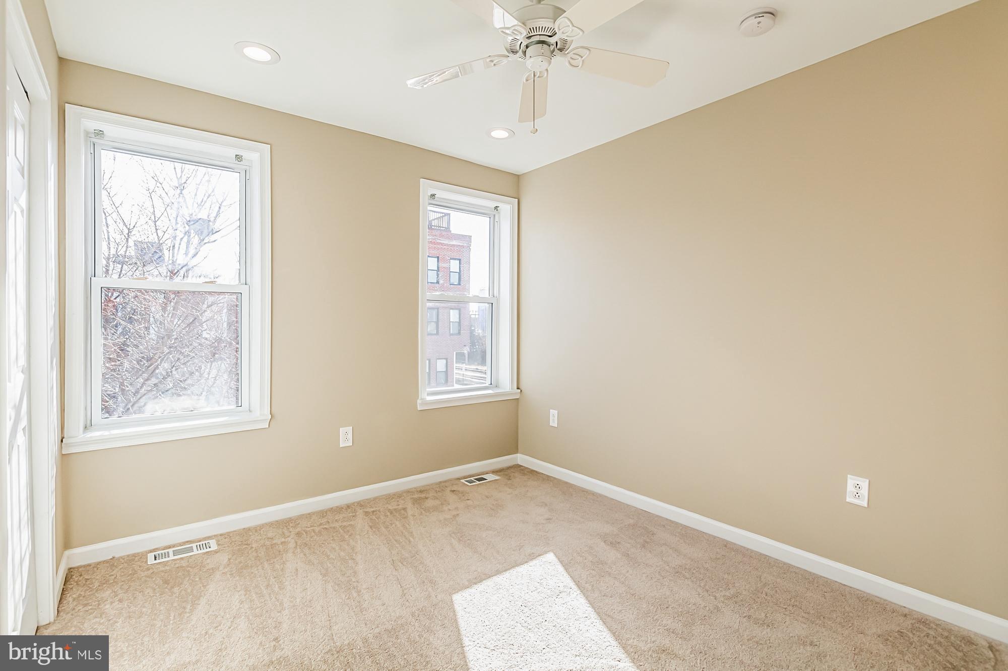 130 West Randall Street Baltimore, MD 21230 - Photo 18 of 30 an empty room with windows and chandelier fan