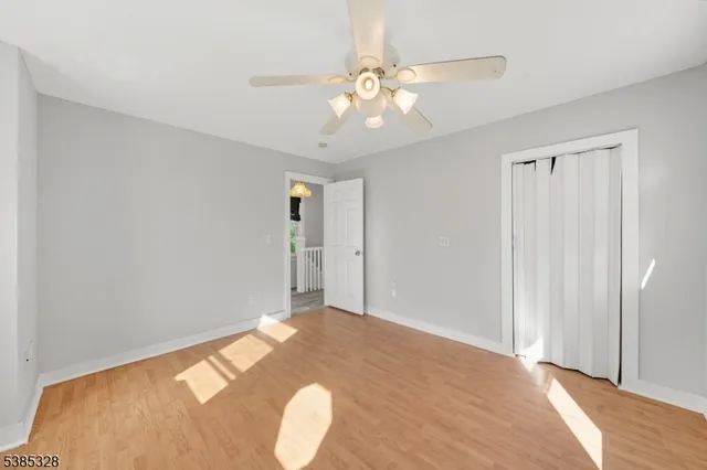 a view of an empty room and wooden floor