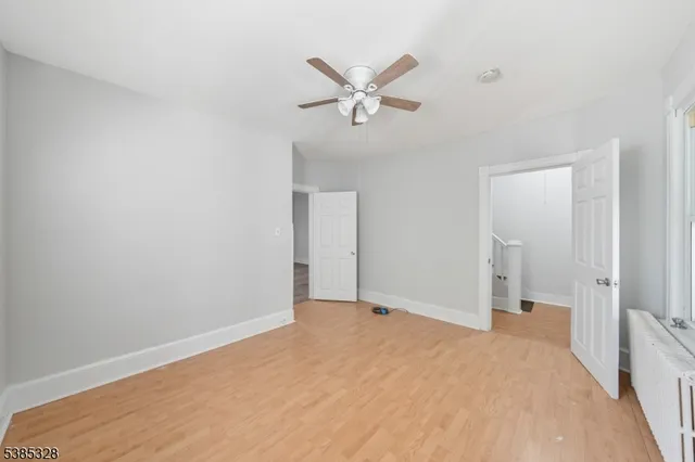 a view of a livingroom with a ceiling fan & a ceiling fan
