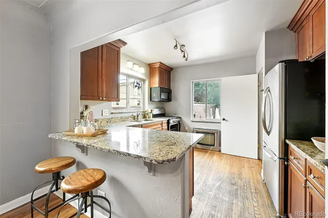 a large kitchen with a table chairs refrigerator and a sink