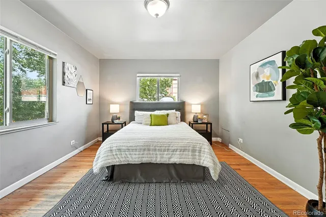a bedroom with a bed lamp and a potted plant