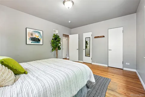 a bedroom with a large bed and a chandelier