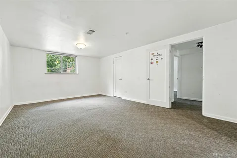 an empty room with windows and closet