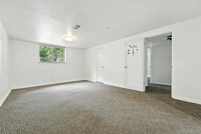 an empty room with windows and closet