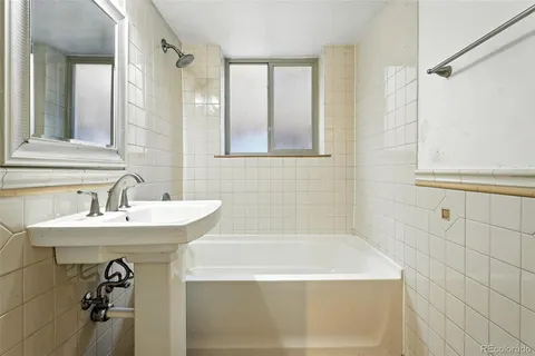 a bathroom with a bathtub and a sink