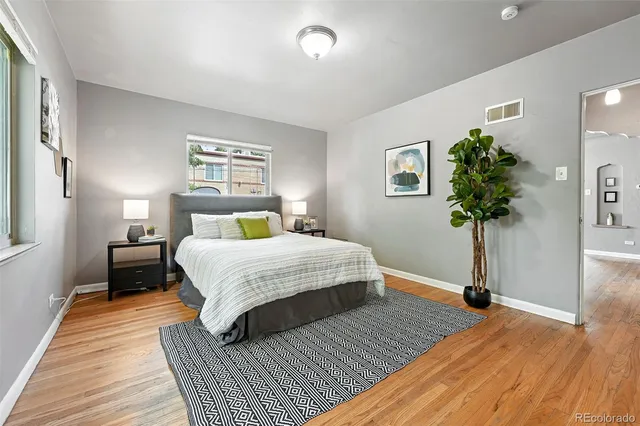 a bedroom with a bed and a potted plant