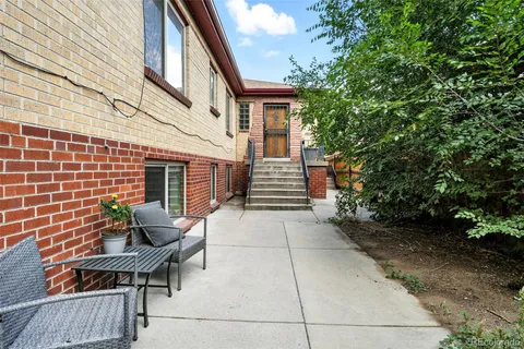 a backyard of a house with outdoor seating