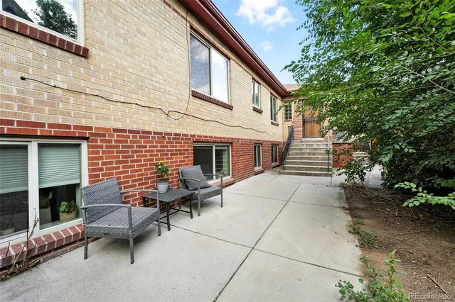 a backyard of a house with outdoor seating
