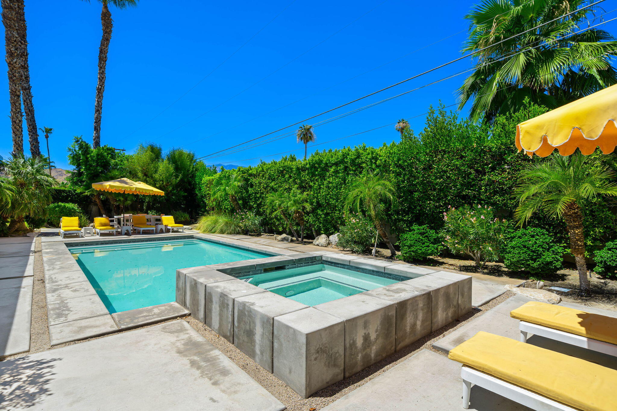 623 Desert Way Palm Springs, CA 92264 - Photo 21 of 39 a view of a swimming pool with a lounge chairs