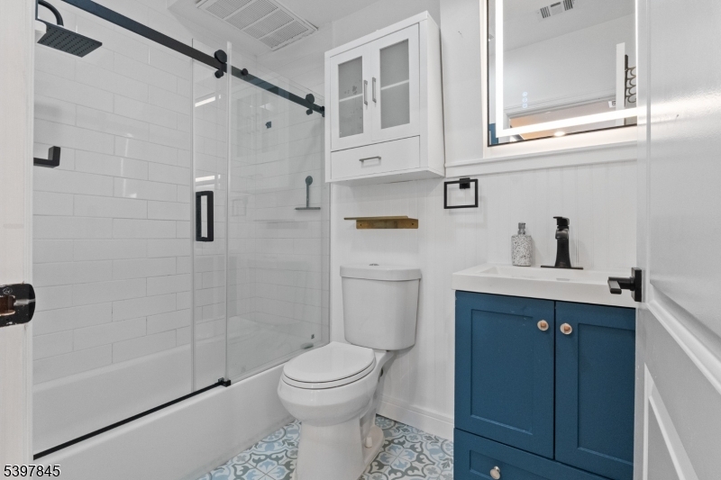 362 1/2 New Street, Unit 2 Newark, NJ 07103 - Photo 1 of 24 a bathroom with a sink a toilet and shower